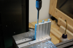 Tapping the vertical part of the bracket.
