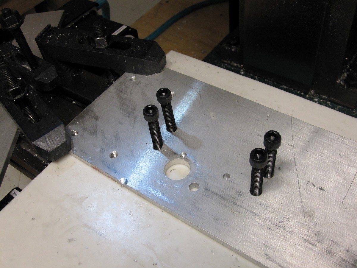 Fixture plate, after drilling.  This scrap of 1/4" aluminum will hold the work piece.